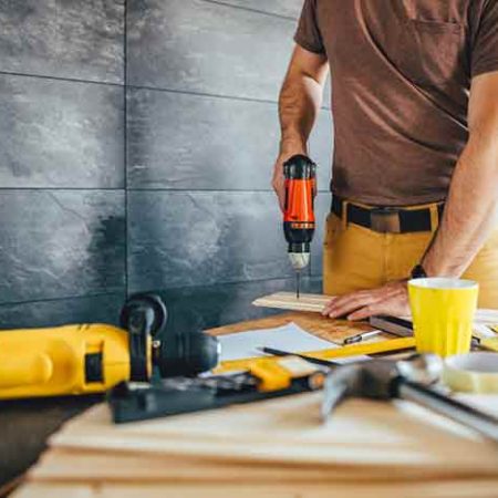 man-drilling-wood-with-battery-power-drill